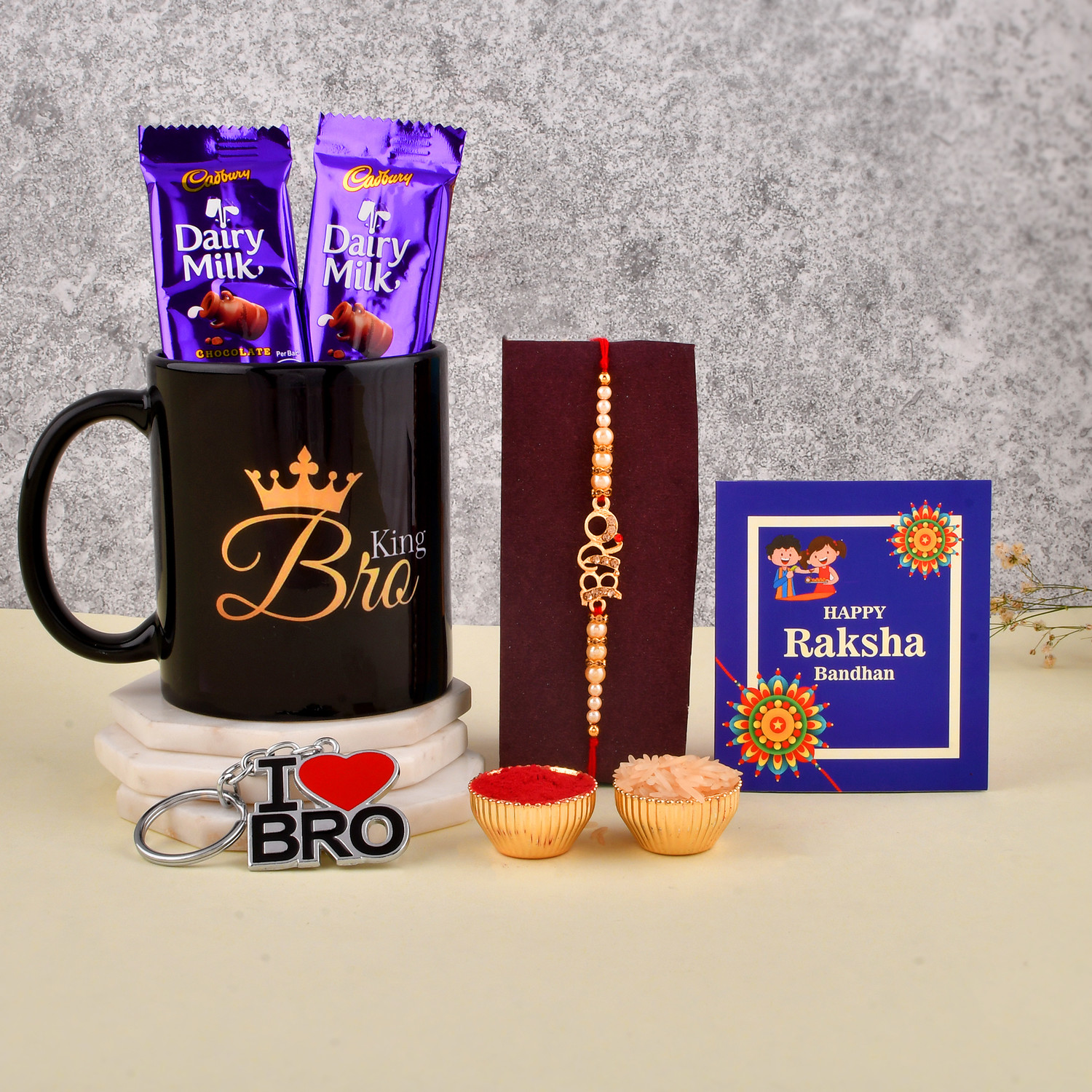 Image of PRIDE STORE Dairy Milk Chocolate With Mug, Rakhi, Keychain Roli Chawal Greeting Card Ceramic Gift Box
