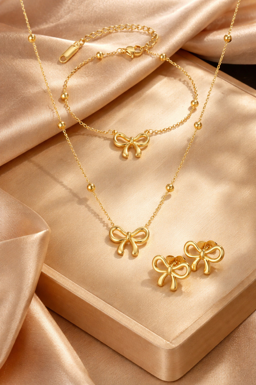 Image of alinora jewels Golden Plated Anti Tarnish Bow Charm 3PC Set Gold-plated Stainless Steel Pendant Set