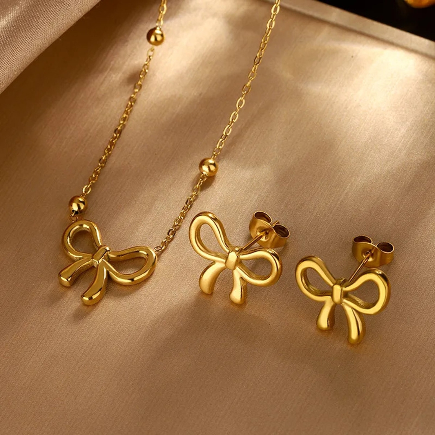 Image of alinora jewels Golden Plated Anti Tarnish Bow Charm 3PC Set Gold-plated Stainless Steel Pendant Set