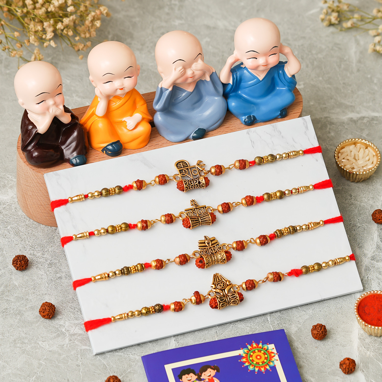 Image of Rudraksh 4 Monk Buddha With Beautiful 4 Rakhi Set Assorted Rakhi, Chawal Roli Pack, Greeting Card Set by PRIDE STORE