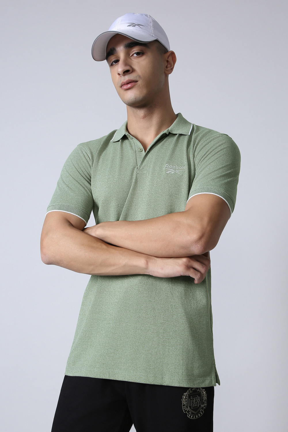 Image of REEBOK Men Solid Polo Neck Polyester Green T-Shirt