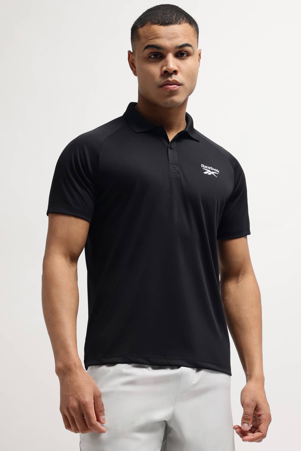 REEBOK Men Solid Polo Neck Polyester Black T-Shirt