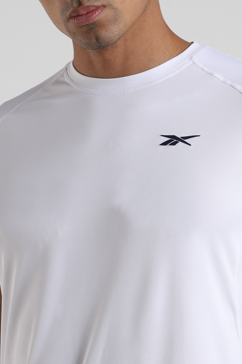 Image of REEBOK Solid Men Round Neck White T-Shirt