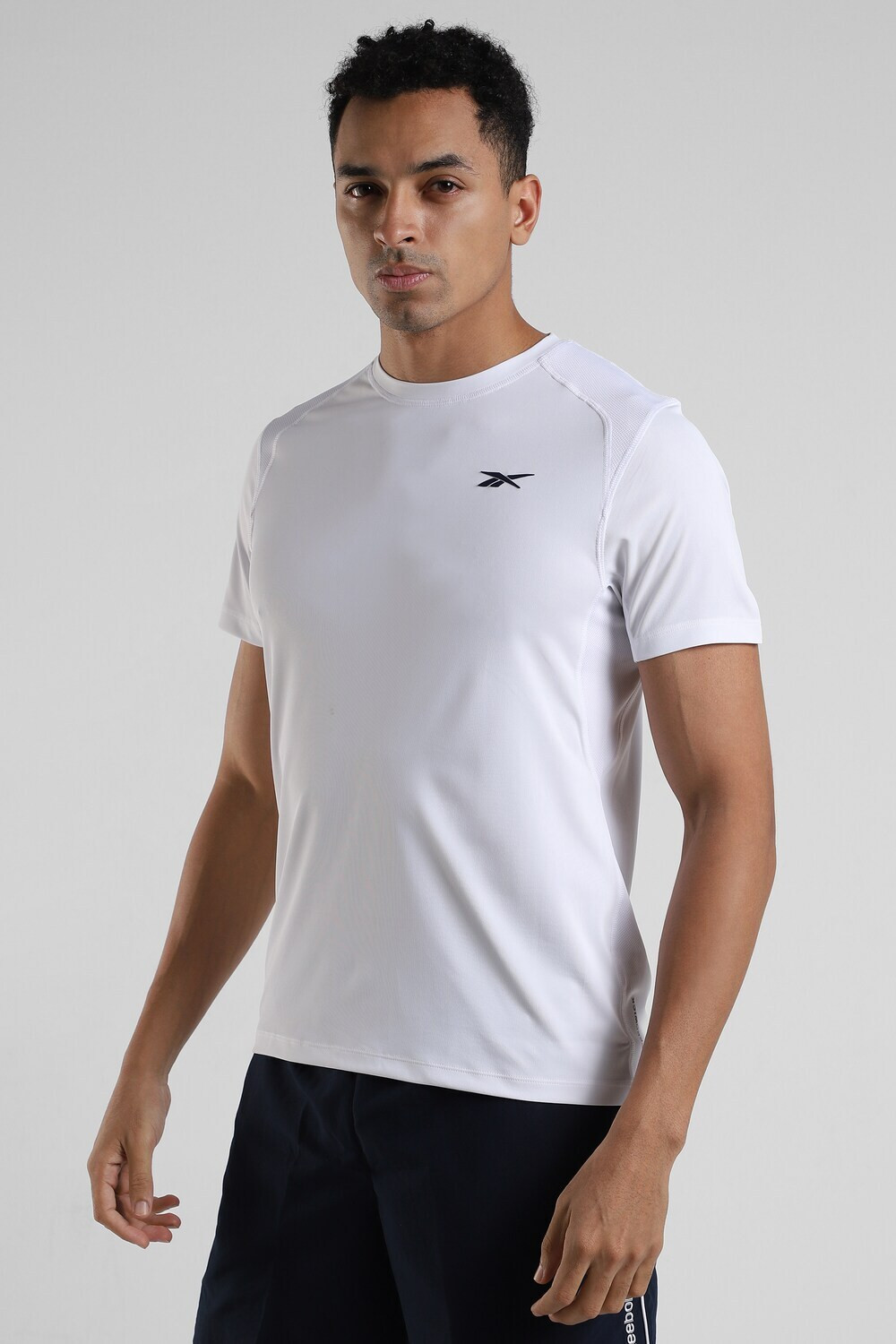 Image of REEBOK Solid Men Round Neck White T-Shirt