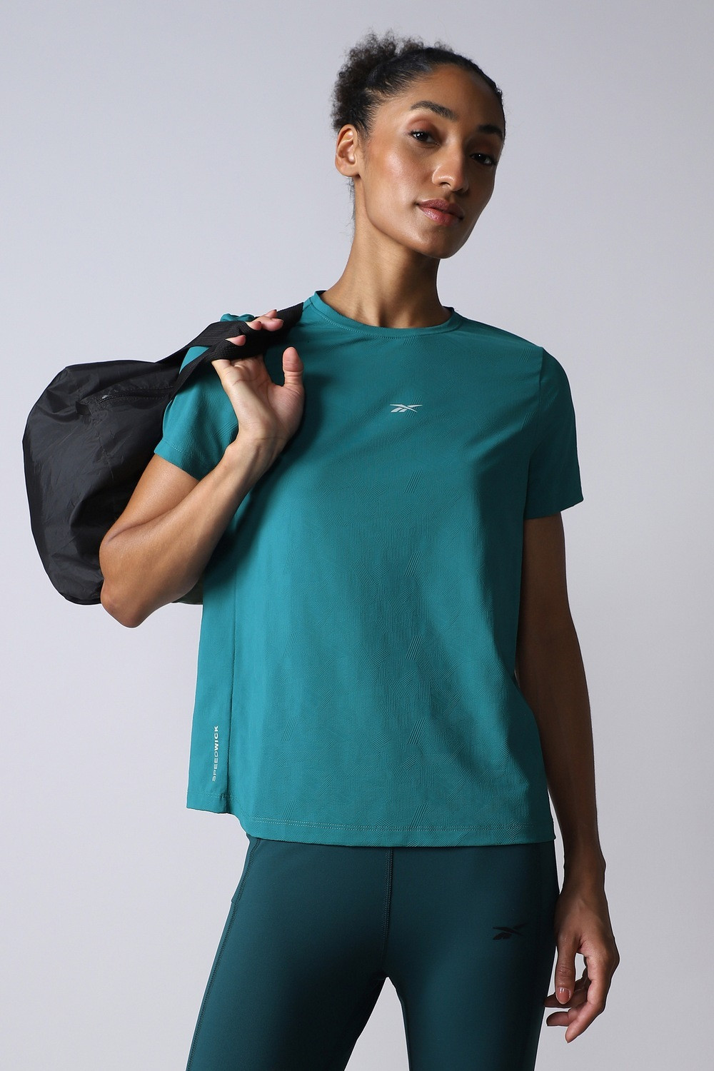 Image of REEBOK Women Solid Round Neck Polyester Blue T-Shirt