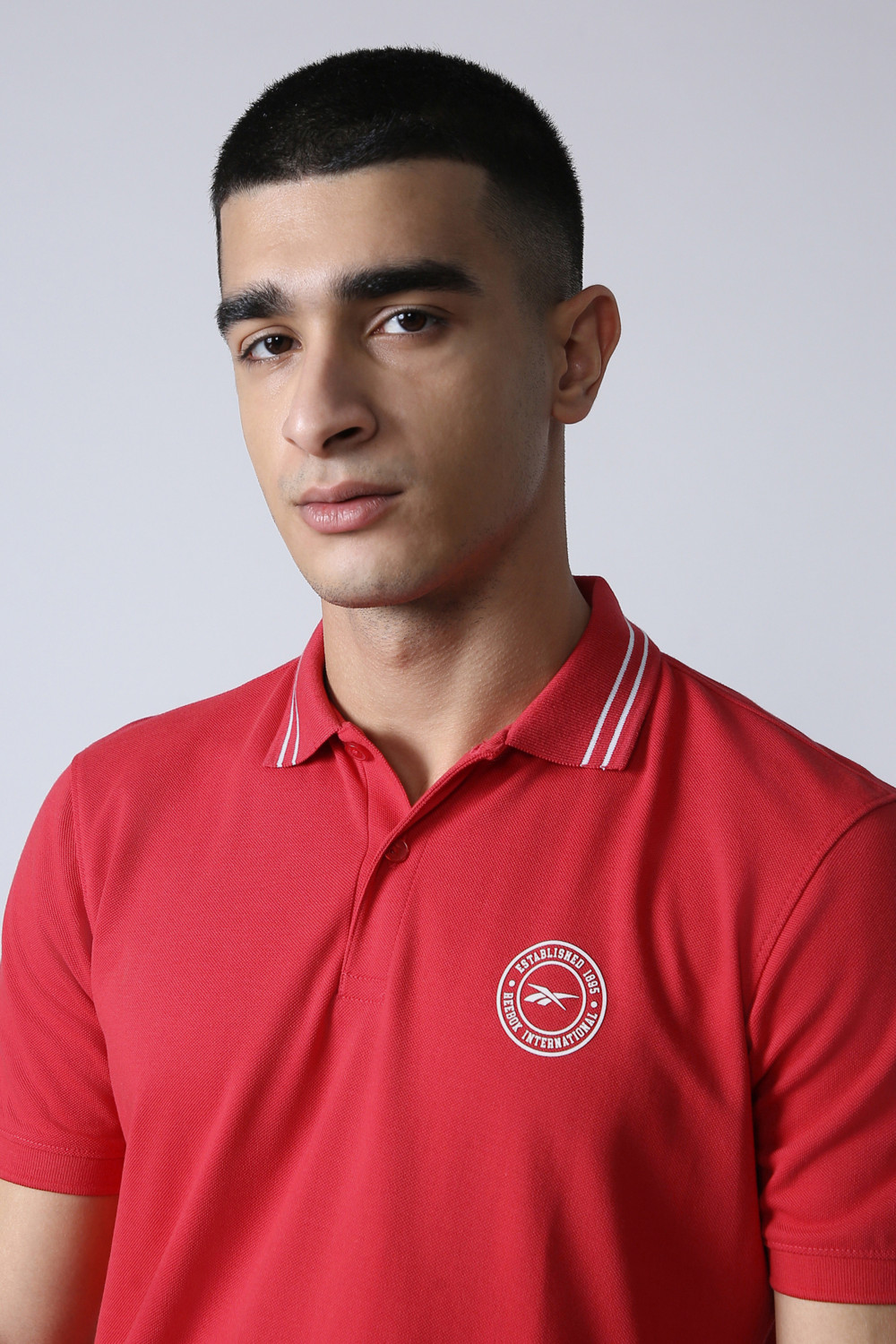 Image of REEBOK Men Solid Polo Neck Polyester Red T-Shirt