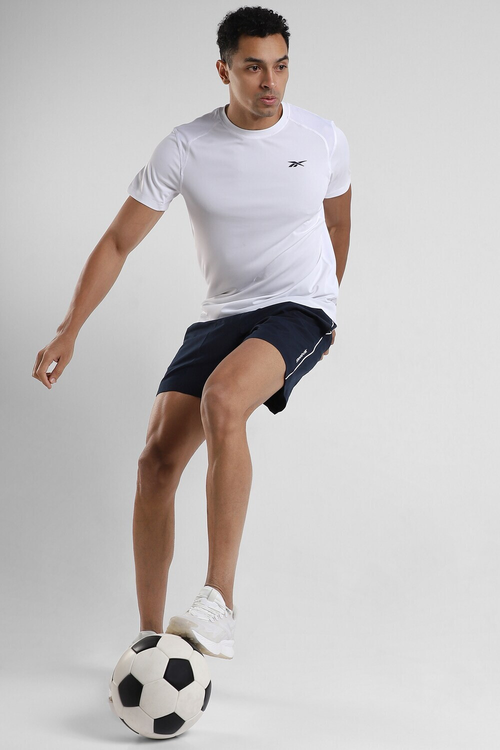 Image of REEBOK Solid Men Round Neck White T-Shirt