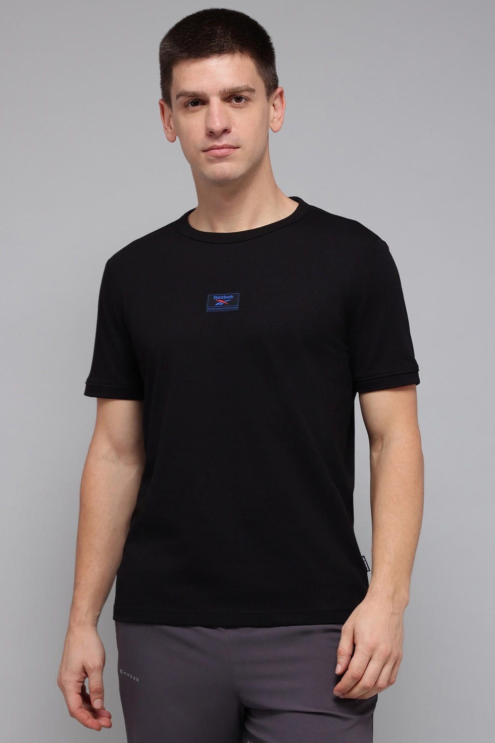 Image of REEBOK Solid Men Round Neck Black T-Shirt