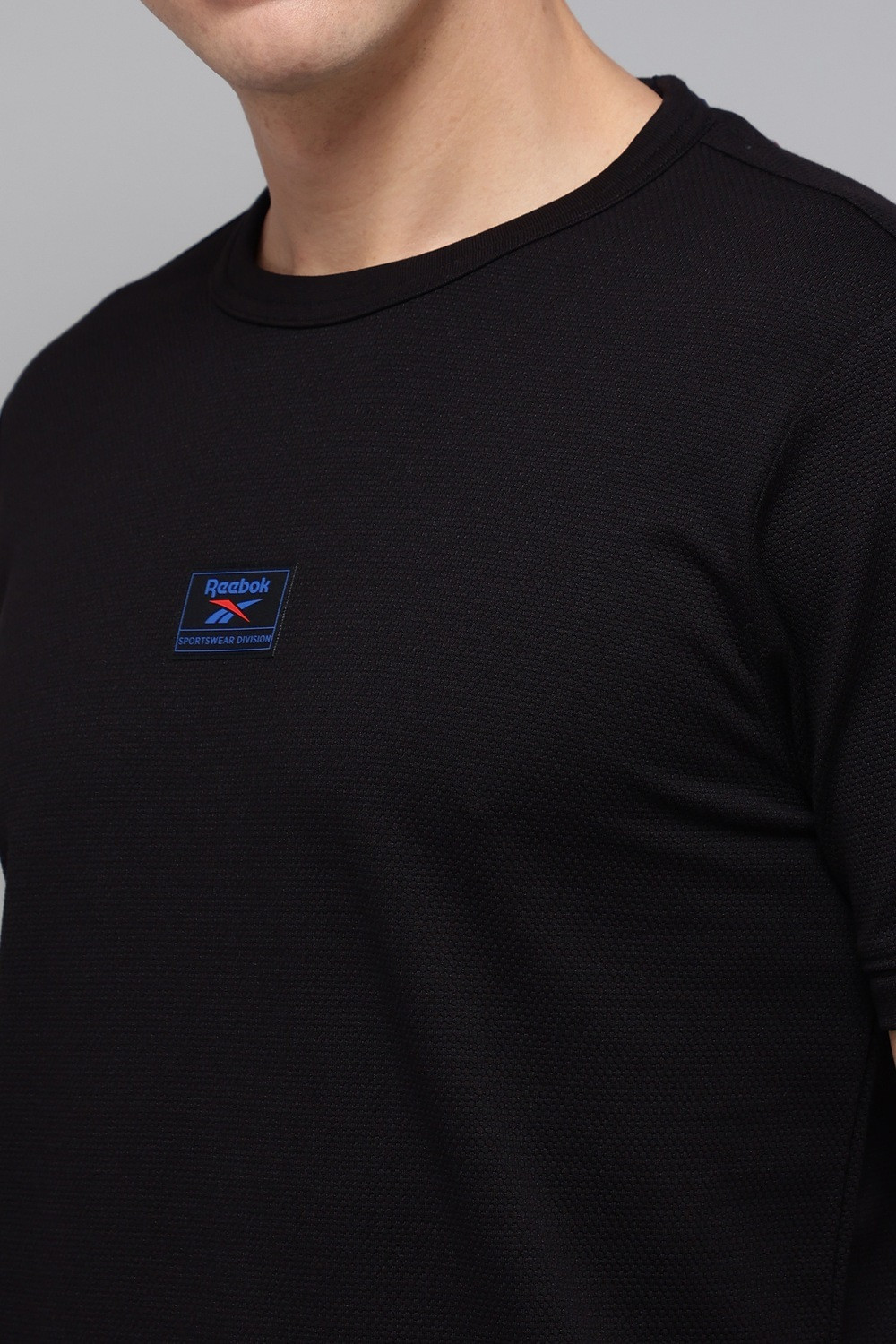 Image of REEBOK Solid Men Round Neck Black T-Shirt