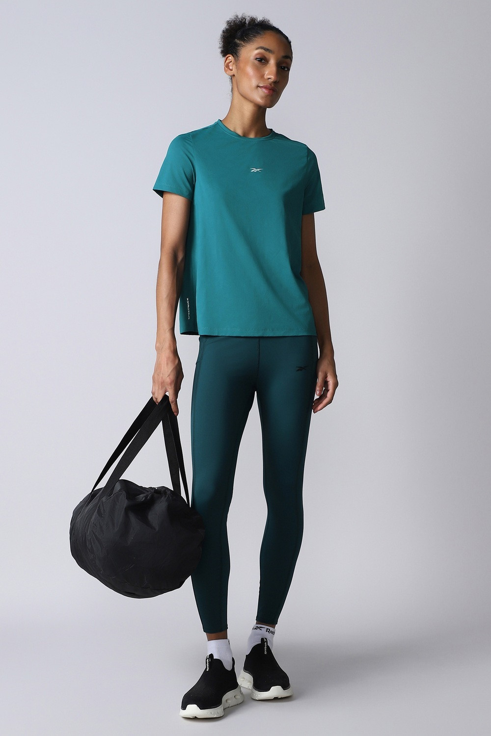 Image of REEBOK Women Solid Round Neck Polyester Blue T-Shirt