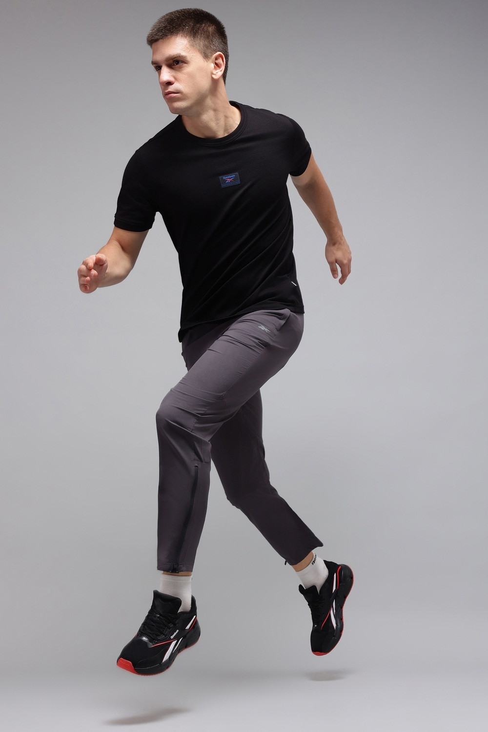 Image of REEBOK Solid Men Round Neck Black T-Shirt