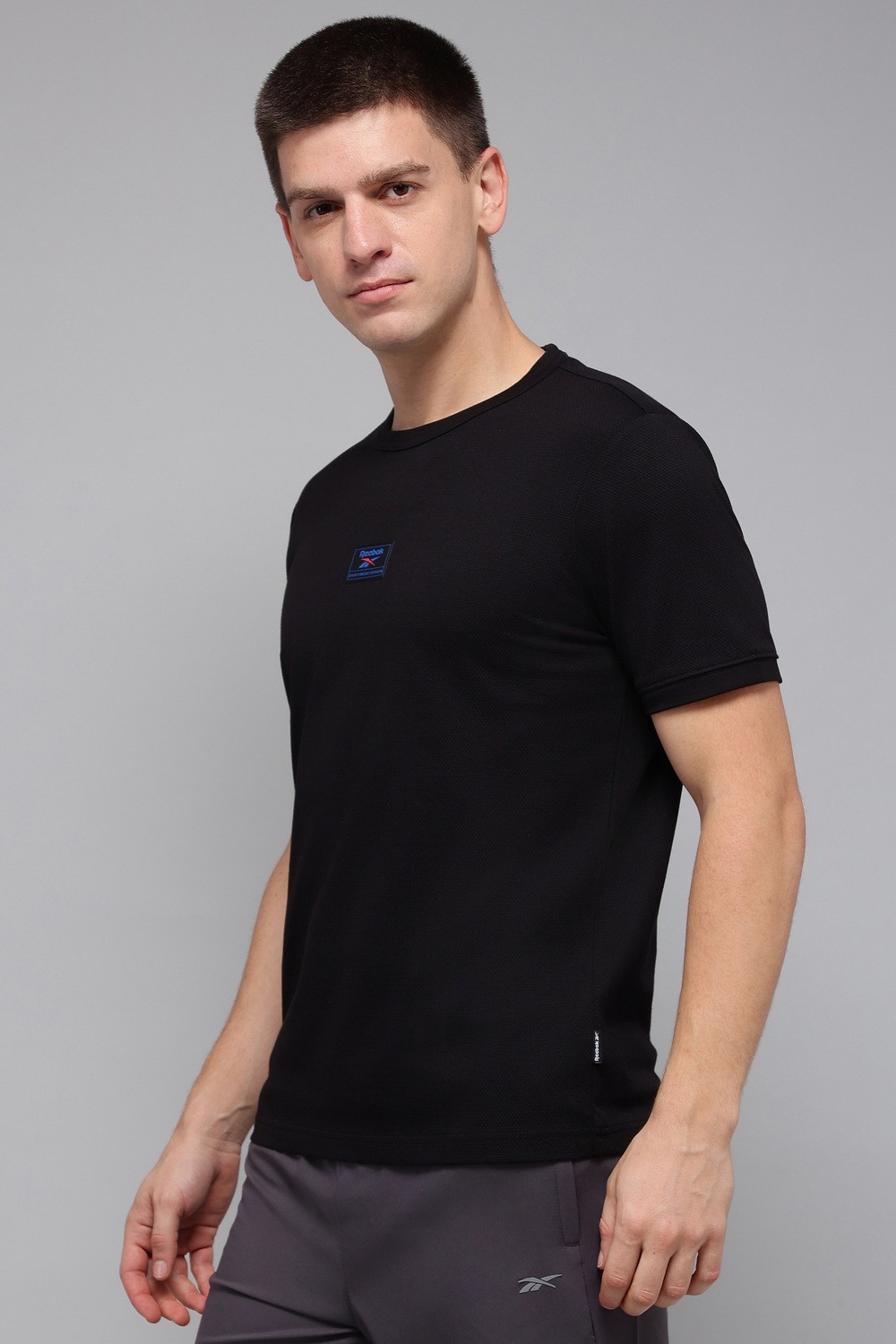 Image of REEBOK Solid Men Round Neck Black T-Shirt