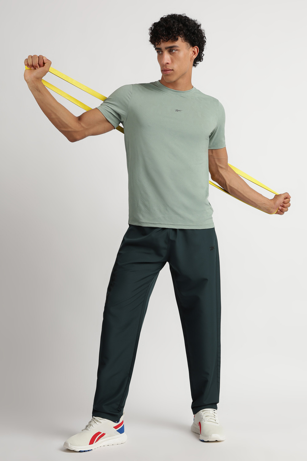 Image of REEBOK Solid Men Dark Green Track Pants