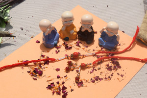 GW Creations Rudraksh Shri Red Stone Rakhi With Mini Buddha (855) Gold ...