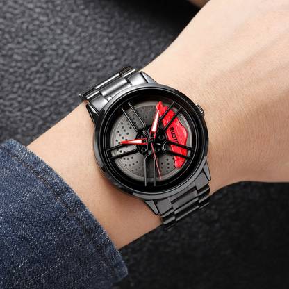 The watch worn on a wrist next to a denim cuff, showing how large the 43 mm case sits